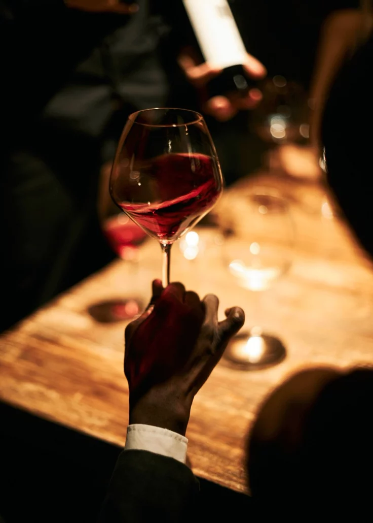 Dimly lit wine cellar with bottles — premium concierge atmosphere